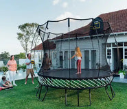 Load image into Gallery viewer, family playing around a trampoline
