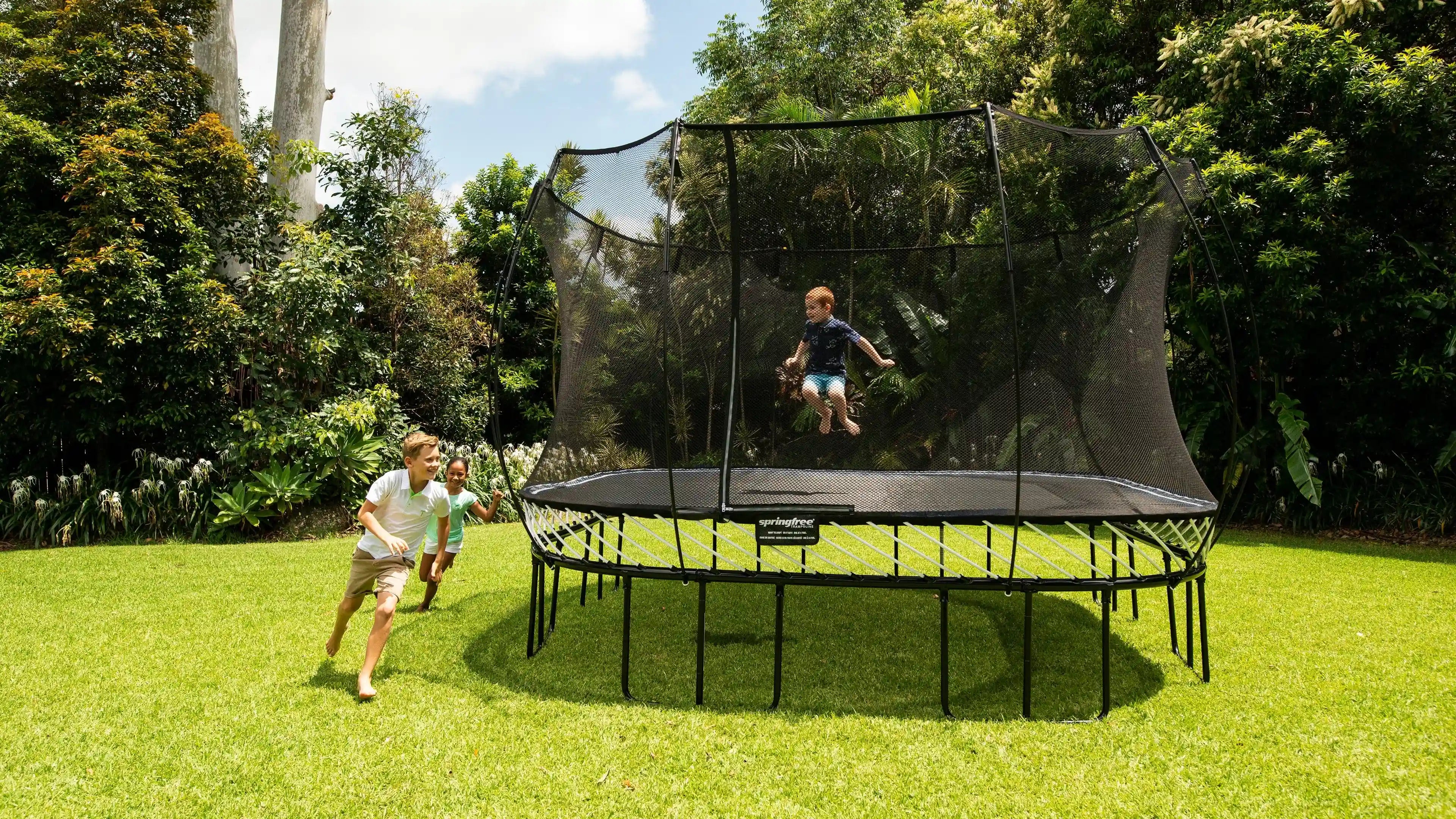 Kids playing around a trampoline