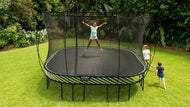 Load image into Gallery viewer, girl jumping on a trampoline while kids are playing around
