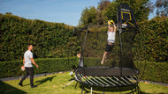 Load image into Gallery viewer, boy playing hoop on a trampoline