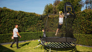 Load image into Gallery viewer, boy playing hoop on a trampoline

