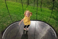 Load image into Gallery viewer, girl jumping on a trampoline
