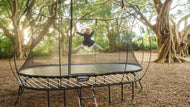 Load image into Gallery viewer, girl jumping on an outdoor trampoline
