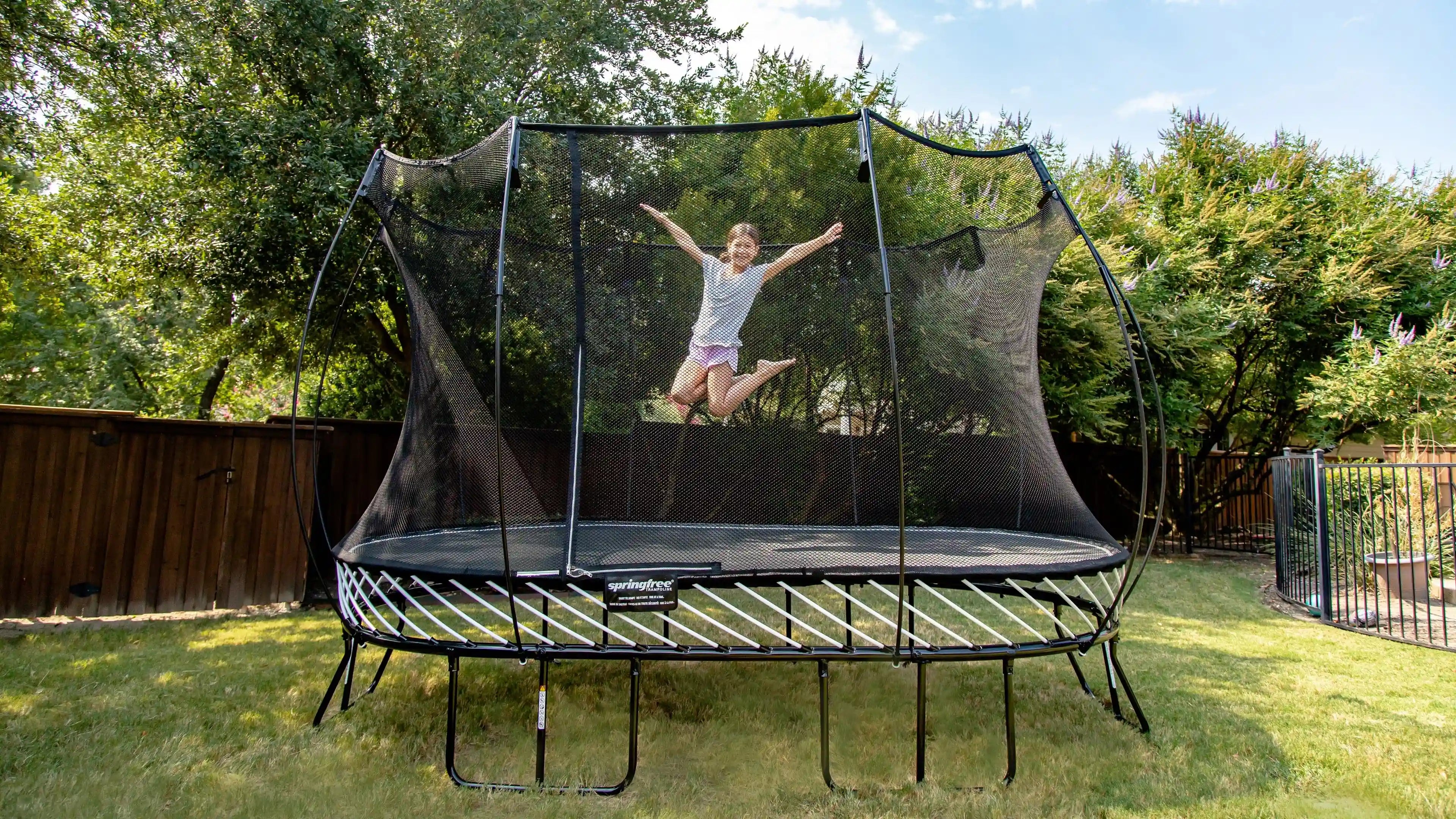 girl jumping high on a trampoline