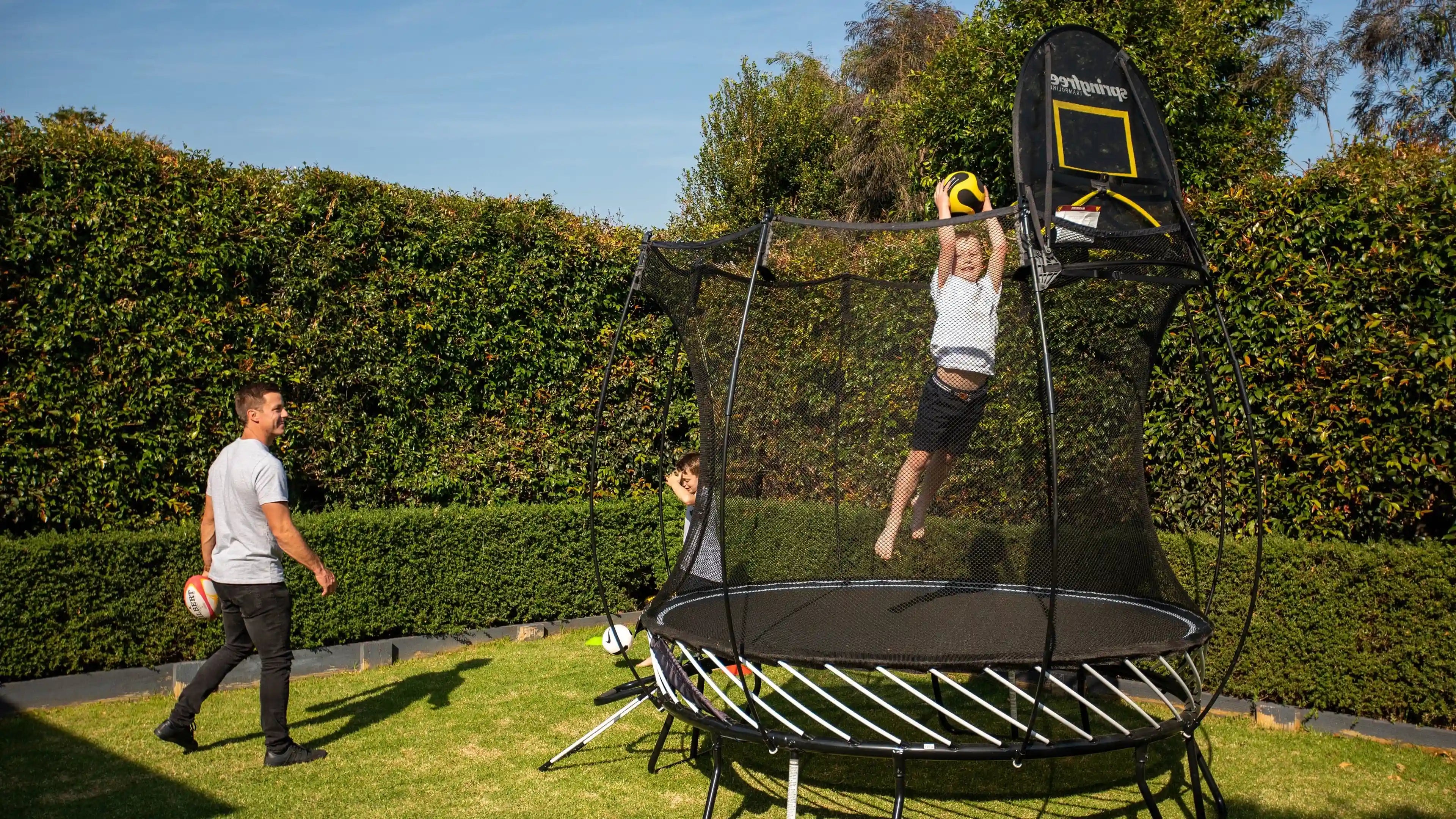 boy playing hoop on a trampoline
